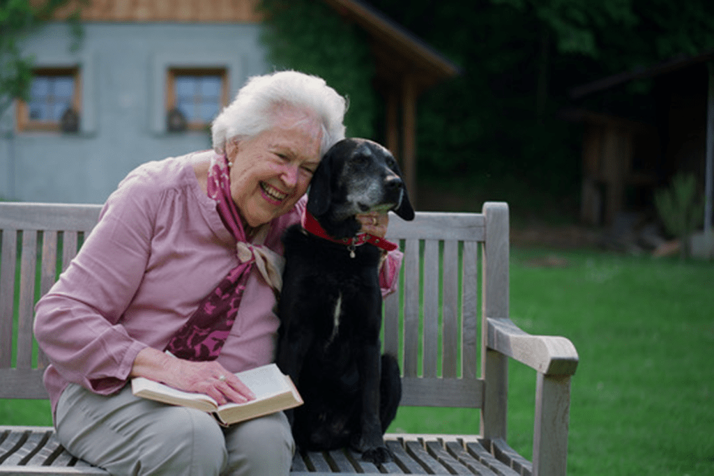 Elderly dog with a senior woman